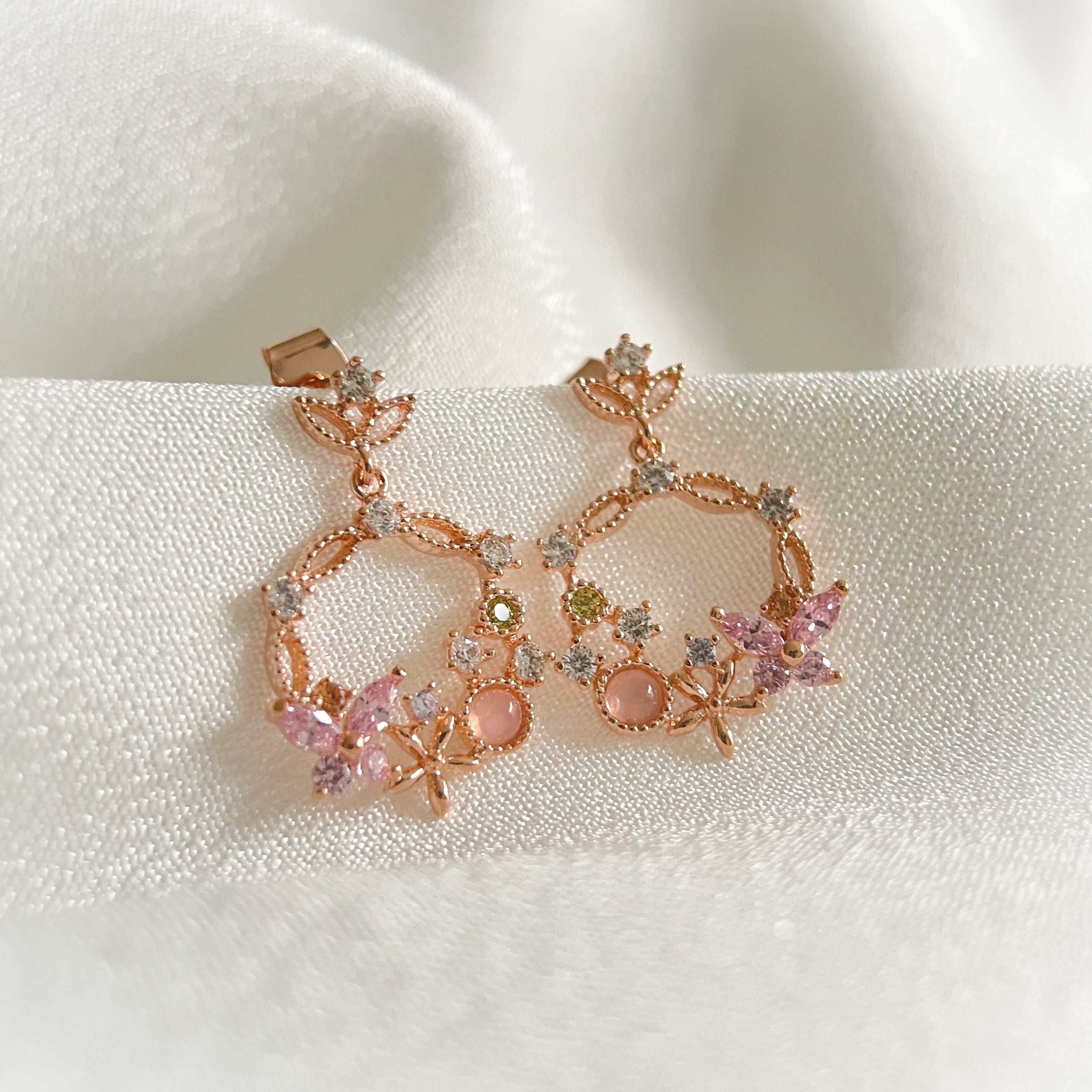 Pair of Rose Gold Drop earrings crafted with pink gemstone in butterfly design enriched by a flower wreath highlighted by Cubic Zirconia. Ideal colorful Jewelry gift for her in different occasions - Sisilia Jewels