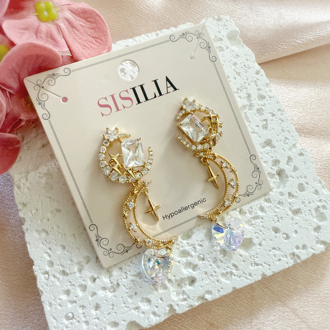 A pair of gold dangle earrings crafted with 14k gold plated brass in celestial crescent moon and shooting star designs highlighted by sparkly cubic zirconia swarovski crystals heart shaped drops. An unique jewelry gift for wedding, prom, party and celebrations
