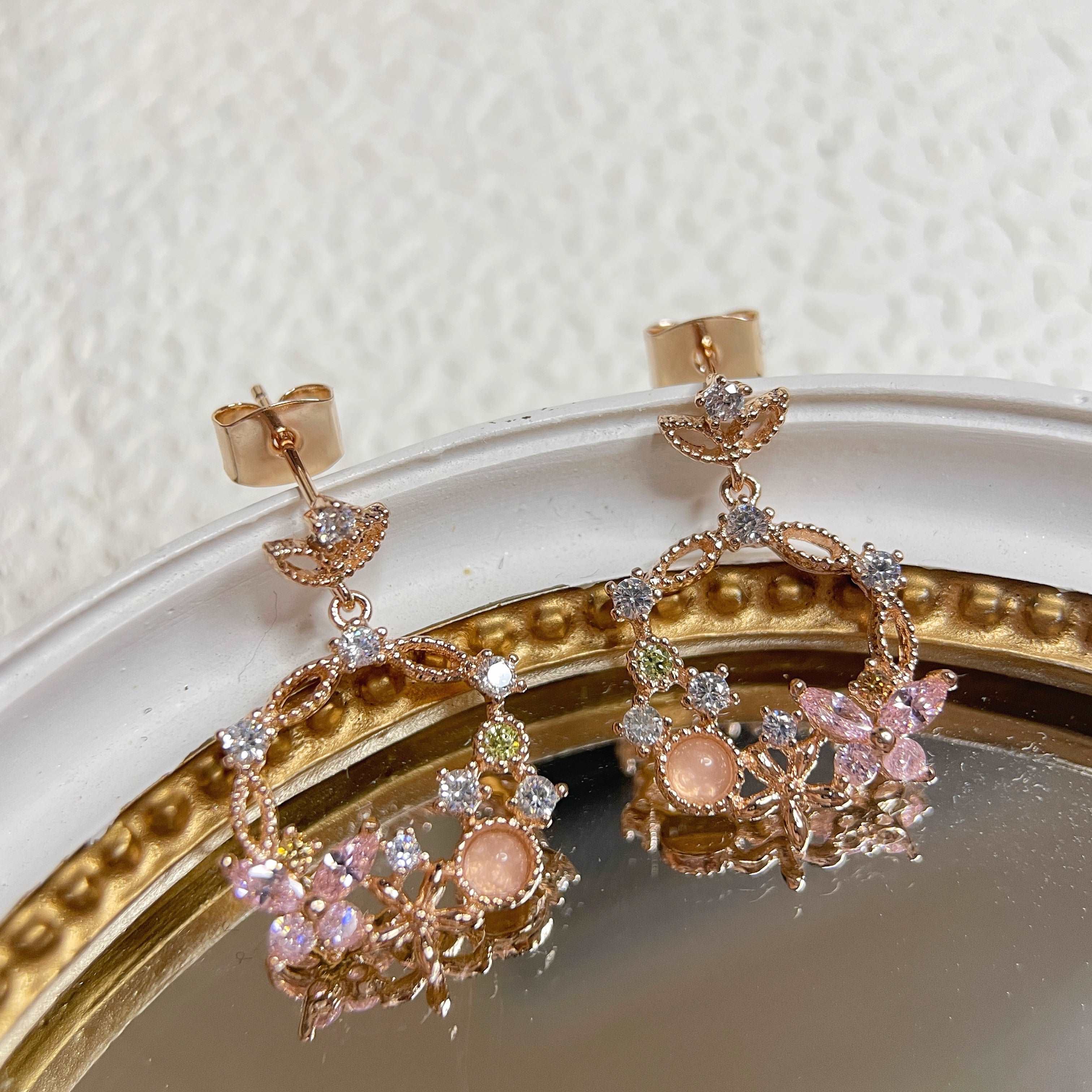 Pair of Rose Gold Drop earrings crafted with pink gemstone in butterfly design enriched by a flower wreath highlighted by Cubic Zirconia. Ideal colorful Jewelry gift for her in different occasions - Sisilia Jewels