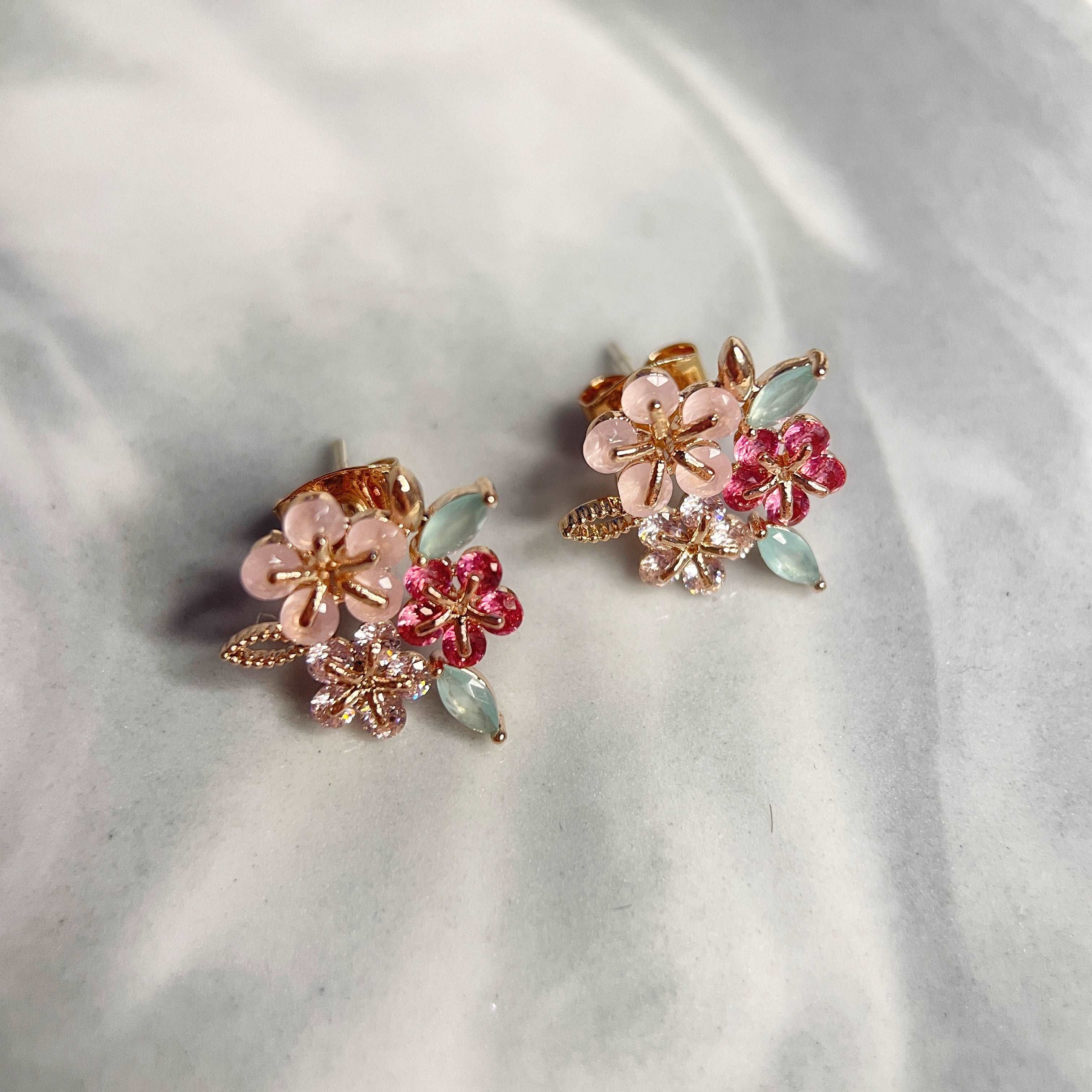 Pair of triple cluster flower earrings studs design in pink, mint green and red, highlighted by rose gold colour leaves with push back earring pin closure - Sisilia Jewels