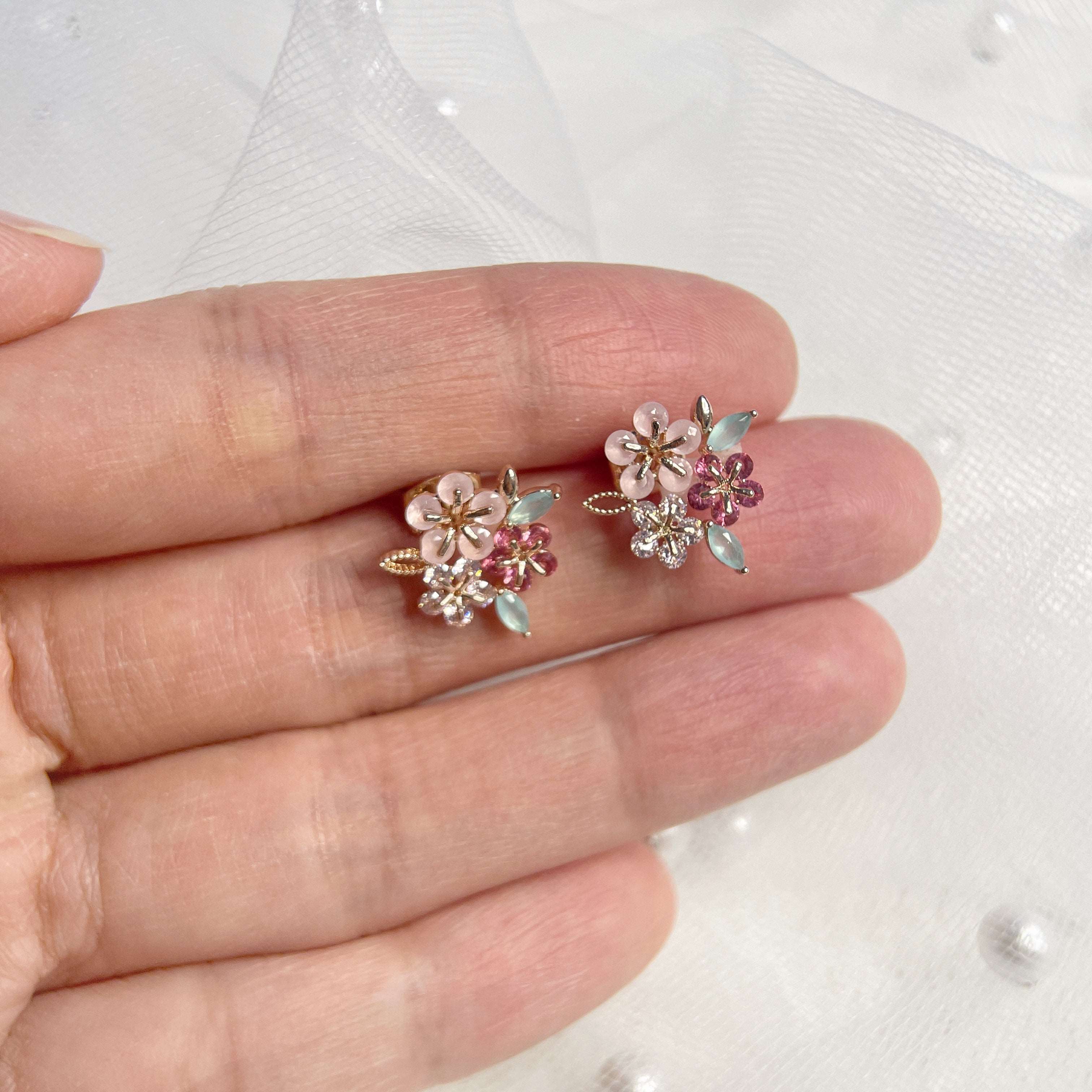 Pair of triple cluster flower earrings studs design in pink, mint green and red, highlighted by rose gold colour leaves with push back earring pin closure - Sisilia Jewels