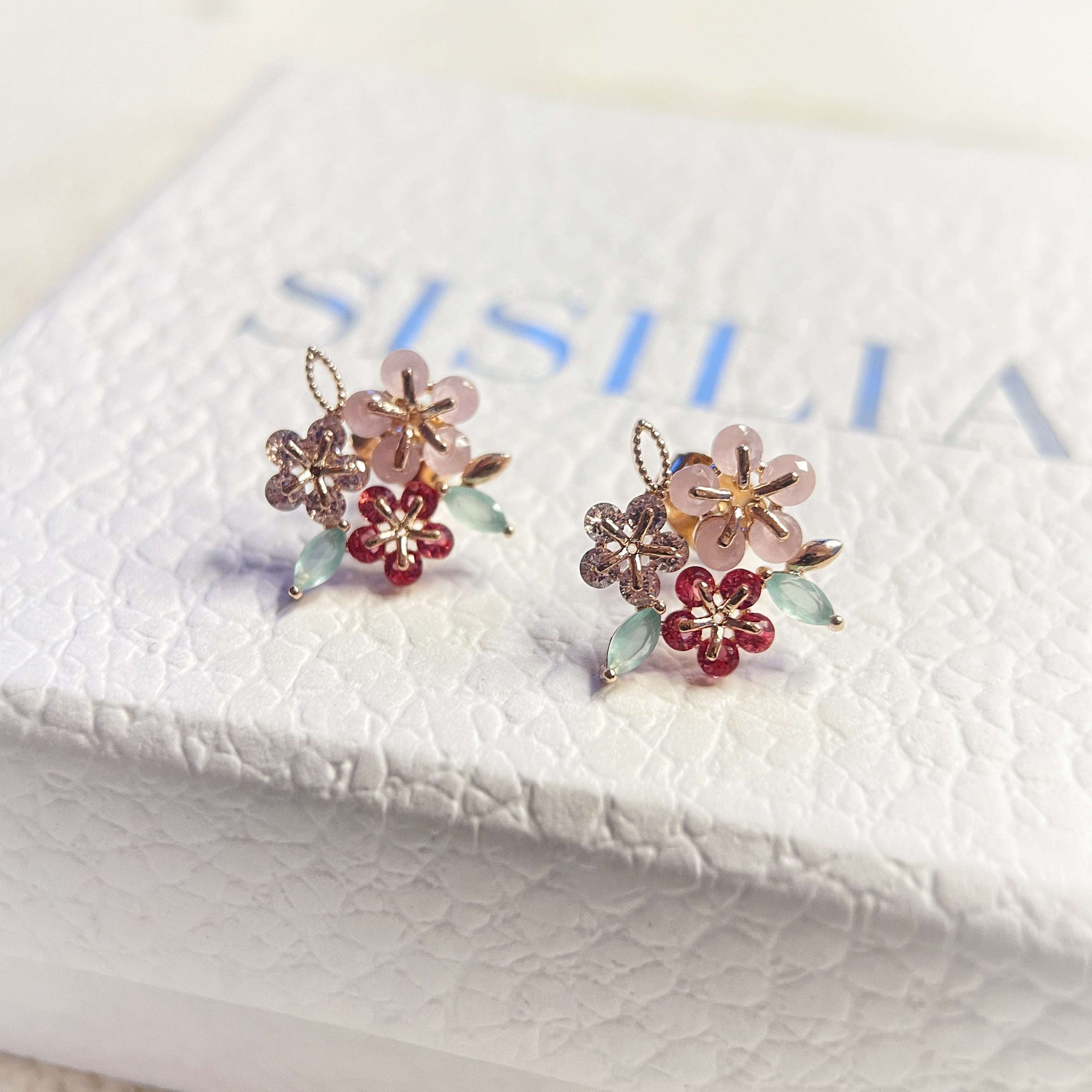 Pair of triple cluster flower earrings studs design in pink, mint green and red, highlighted by rose gold colour leaves with push back earring pin closure - Sisilia Jewels
