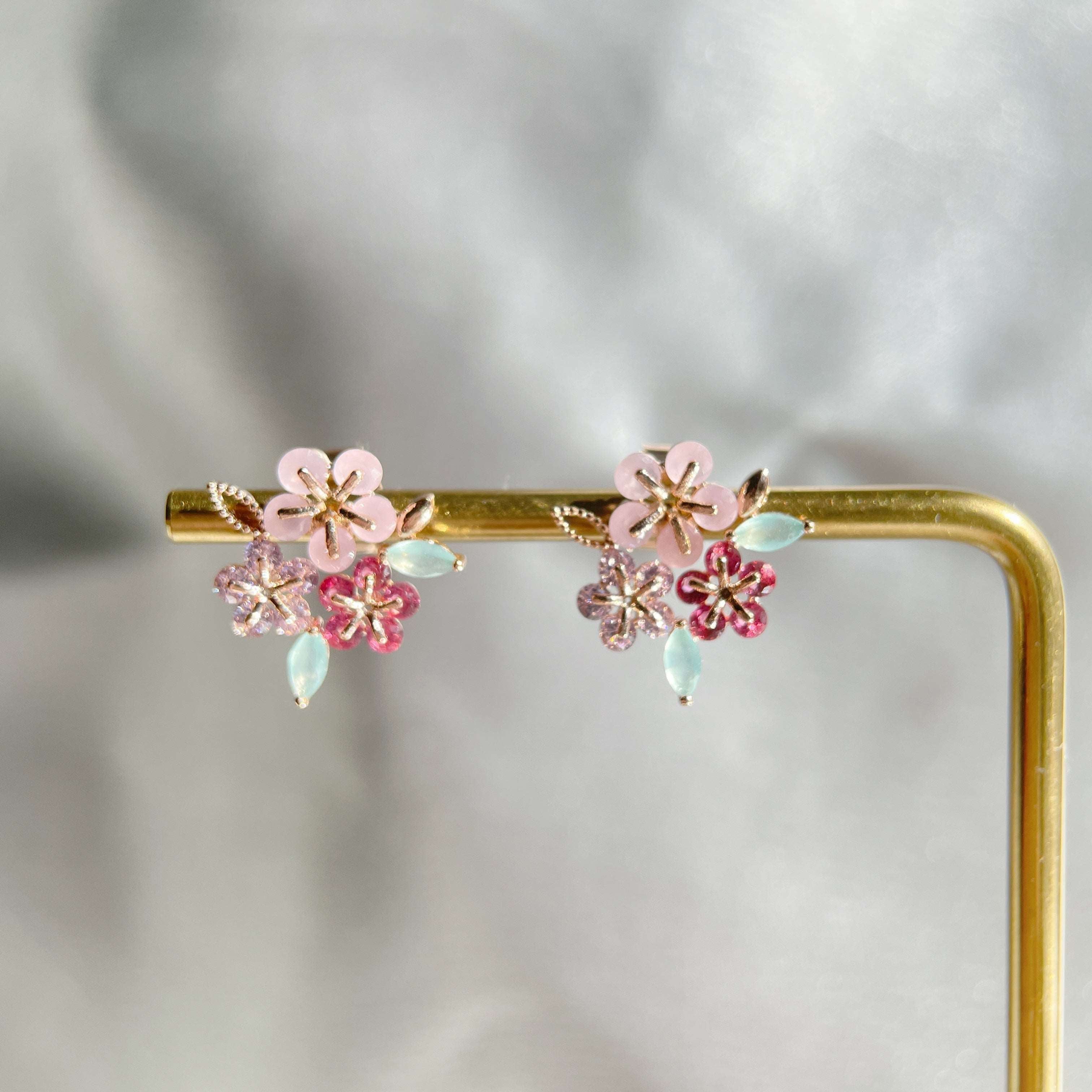 Pair of triple cluster flower earrings studs design in pink, mint green and red, highlighted by rose gold colour leaves with push back earring pin closure - Sisilia Jewels