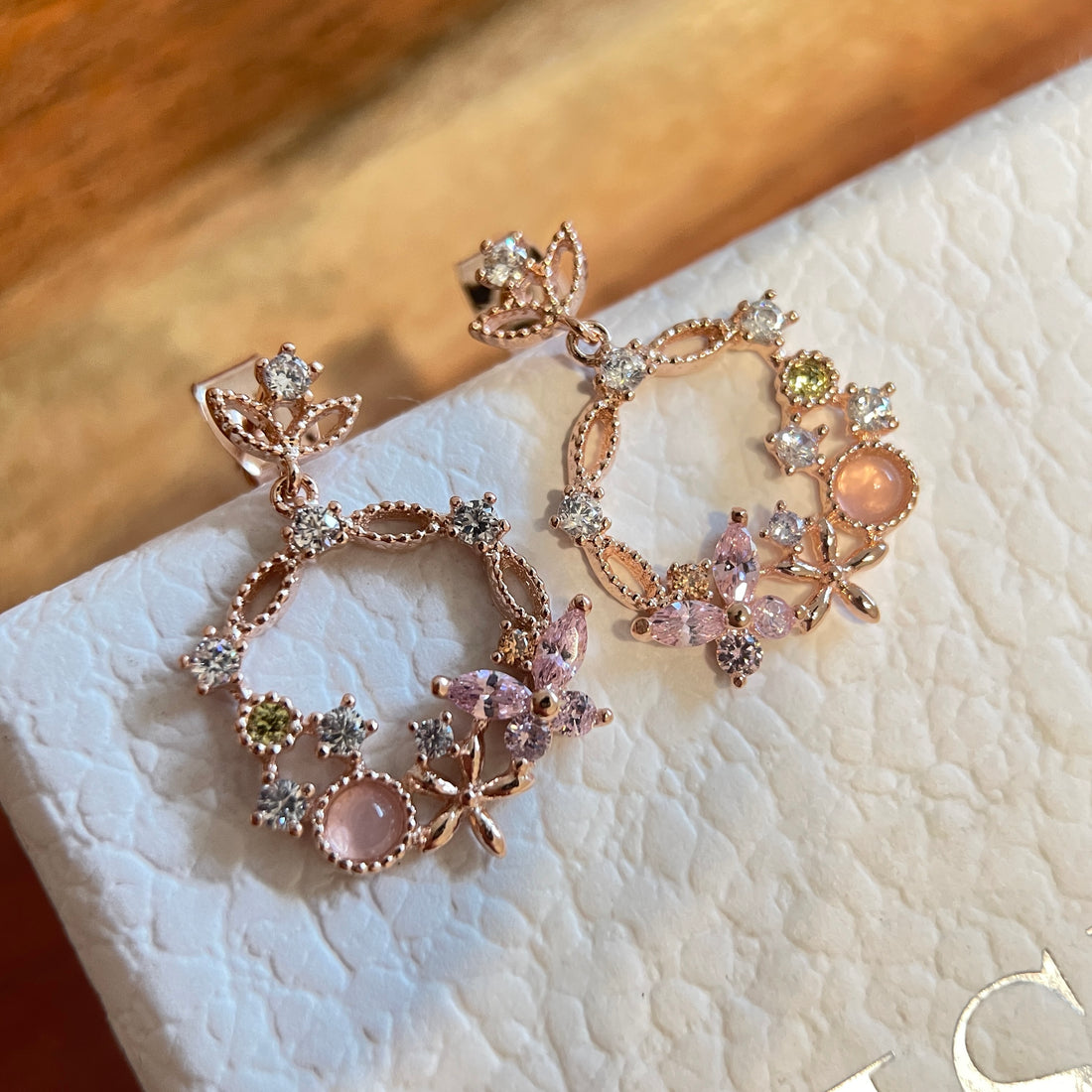 Pair of Rose Gold Drop earrings crafted with pink gemstone in butterfly design enriched by a flower wreath highlighted by Cubic Zirconia. Ideal colorful Jewelry gift for her in different occasions - Sisilia Jewels