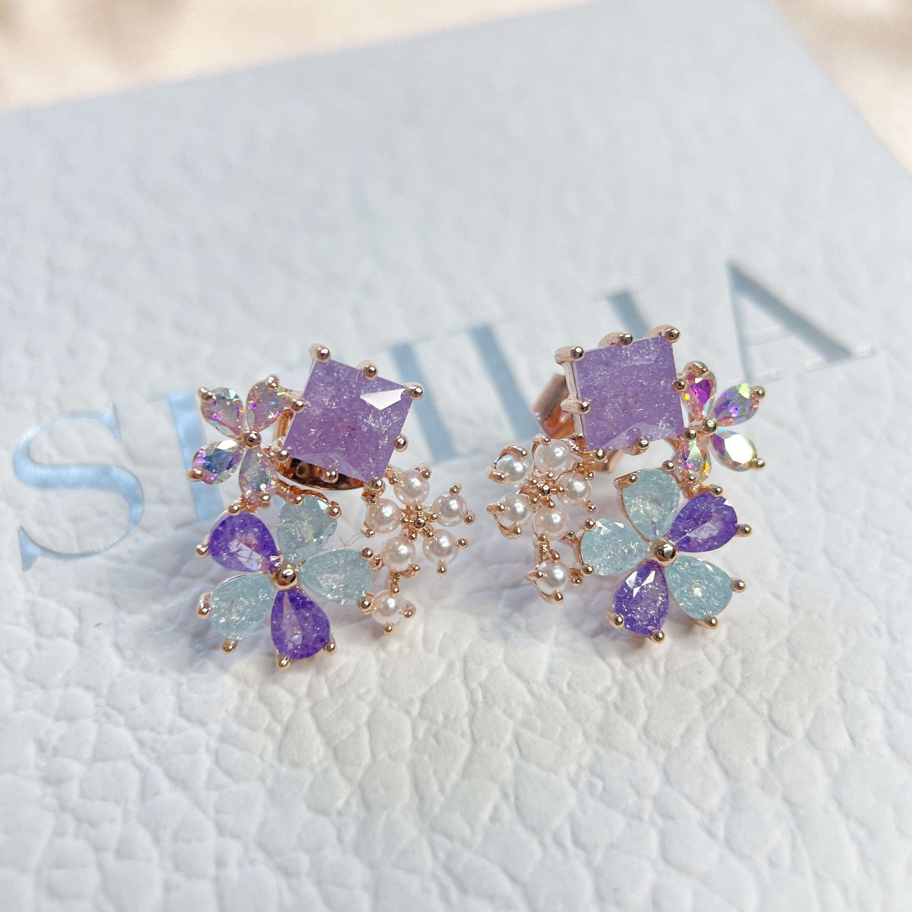 Pair of multi colored stone earring studs crafted with tiny pearls, sparkle crystals, amethyst and aquamarine in dream ethereal bloom style - Sisilia Jewels