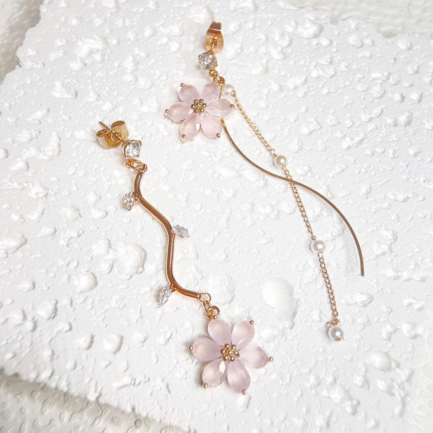 Mismatched earrings in six petals pink flower hanging on rose gold flower stems - Sisilia Jewels