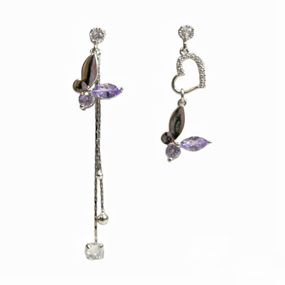 Pair of mismatched earring dangles in dream butterfly design crafted with semi-precious purple and colorless swarovski crystals, as well as a silver heart shape drops and two tassels drops - Sisilia Jewels