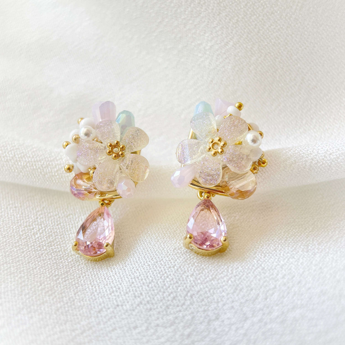 A pair of multi colored stone five petals flower bloom earrings with pink teardrop on white background - Sisilia Jewels