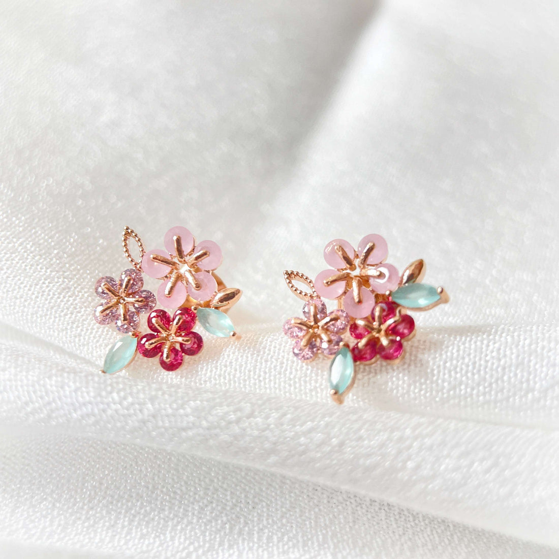 Pair of triple cluster flower earrings studs design in pink, mint green and red, highlighted by rose gold colour leaves with push back earring pin closure - Sisilia Jewels