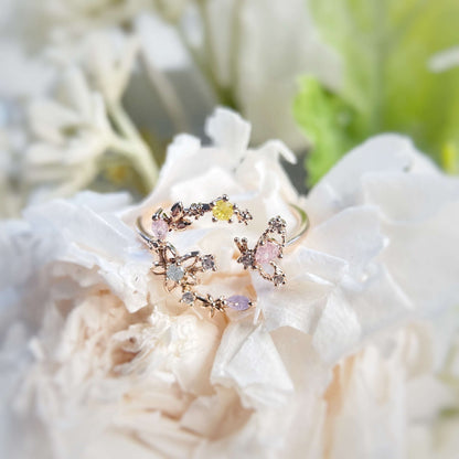 An adjustable rose gold everyday wear ring, with flower wreath in crescent shape adorned with a butterfly wing crafted with colorful gemstones - Sisilia Jewels