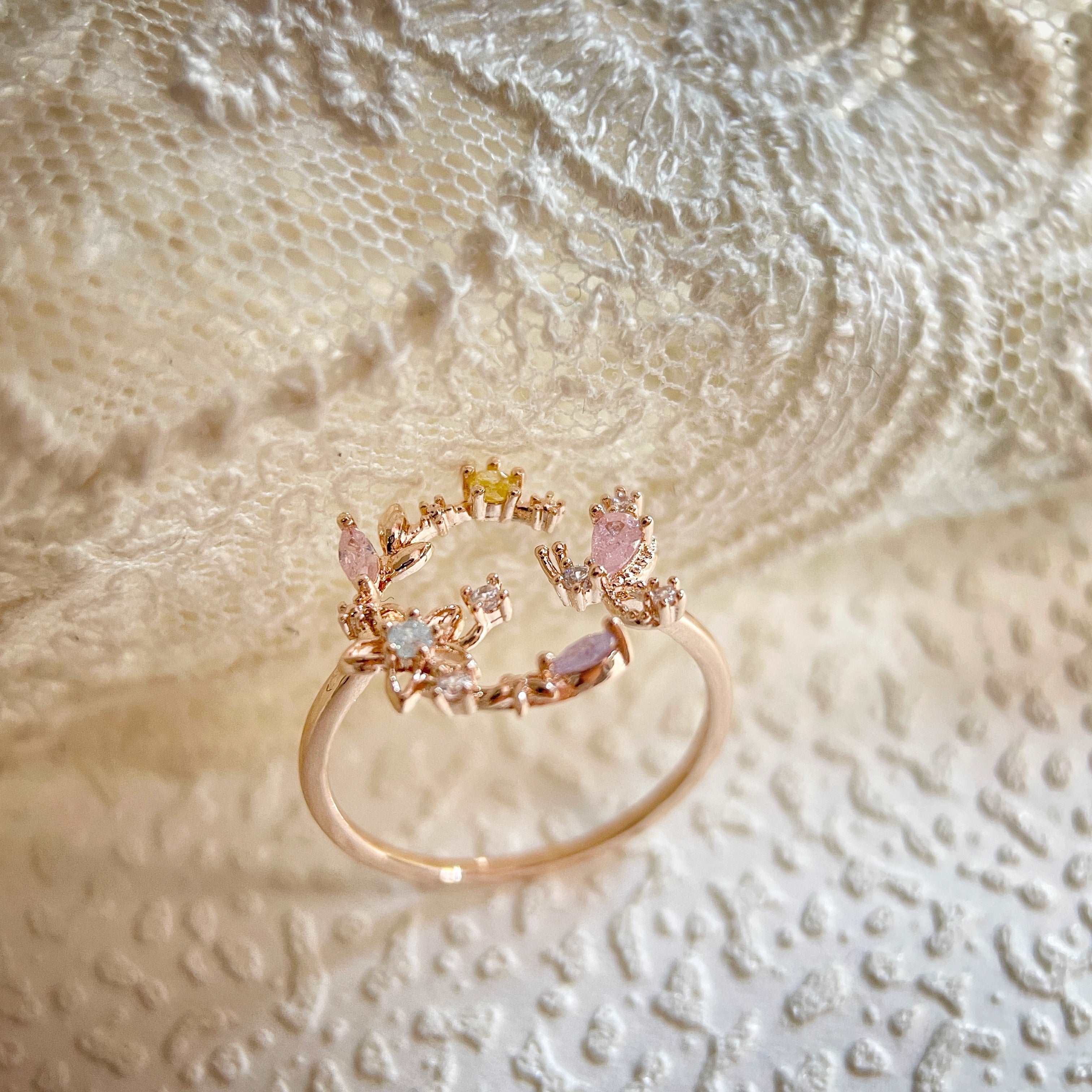 An adjustable rose gold everyday wear ring, with flower wreath in crescent shape adorned with a butterfly wing crafted with colorful gemstones - Sisilia Jewels