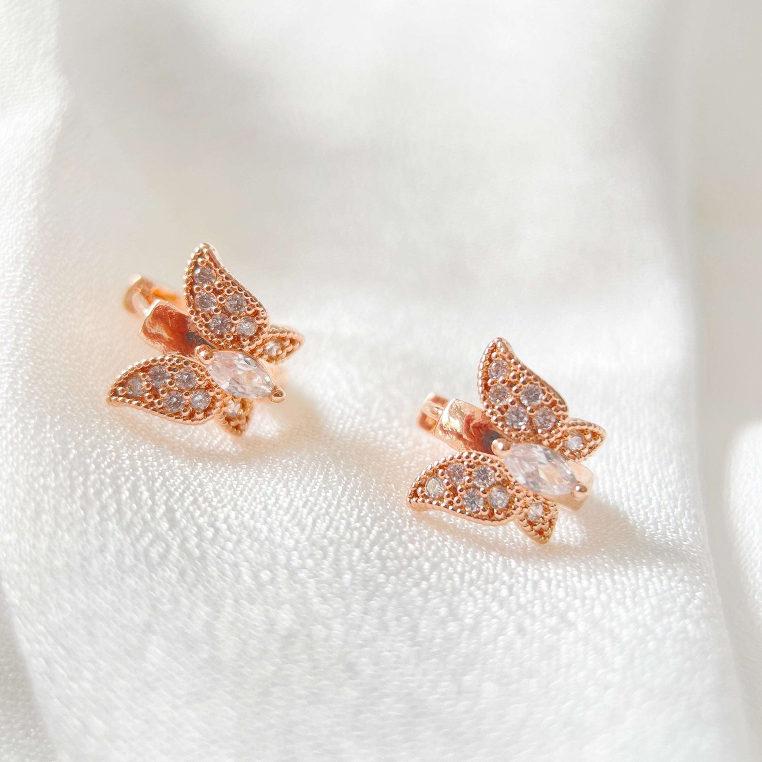 Pair of rose gold huggie earrings in butterfly design paved with cubic zirconia cz stones in one touch closure design - Sisilia Jewels