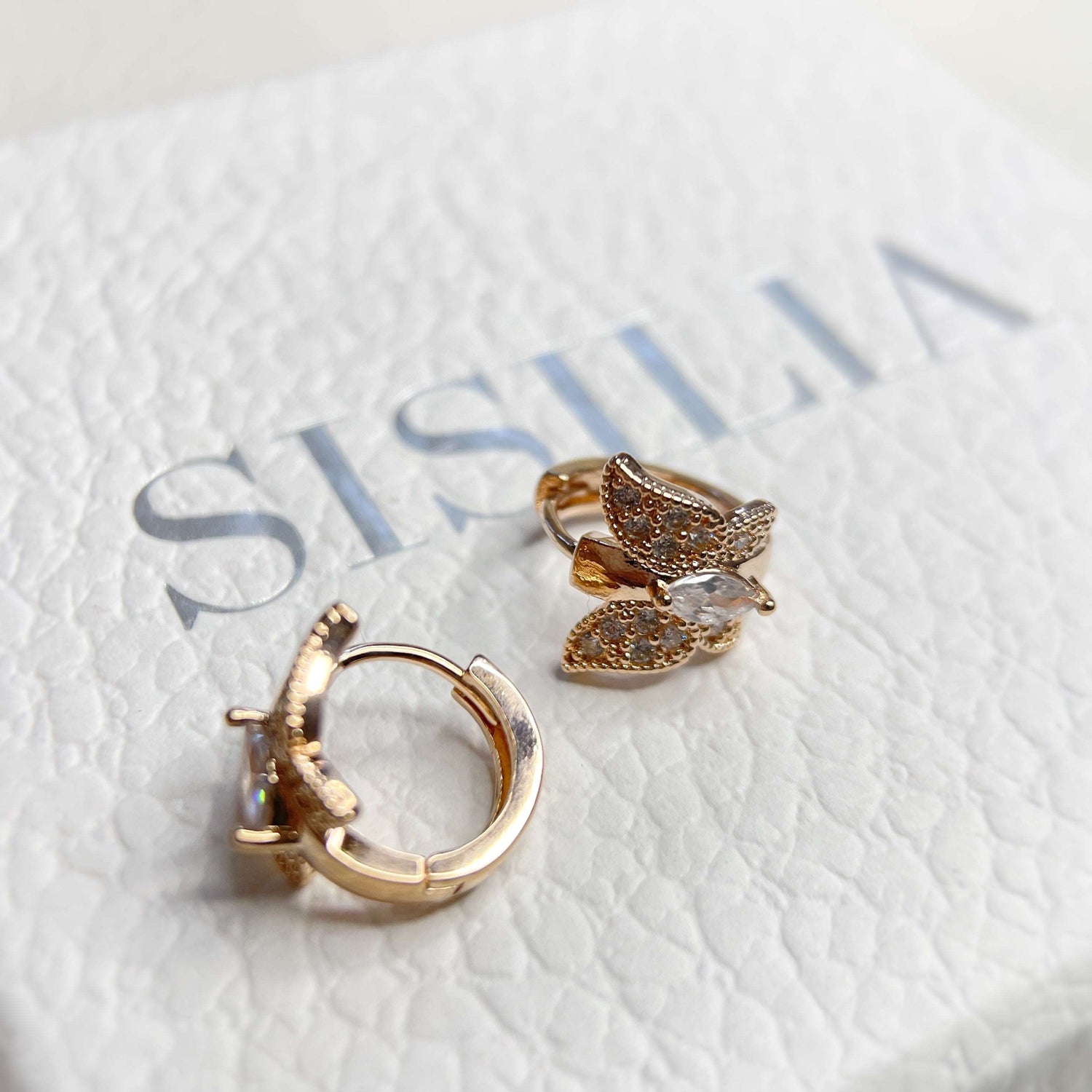 Pair of rose gold huggie earrings in butterfly design paved with cubic zirconia cz stones in one touch closure design - Sisilia Jewels