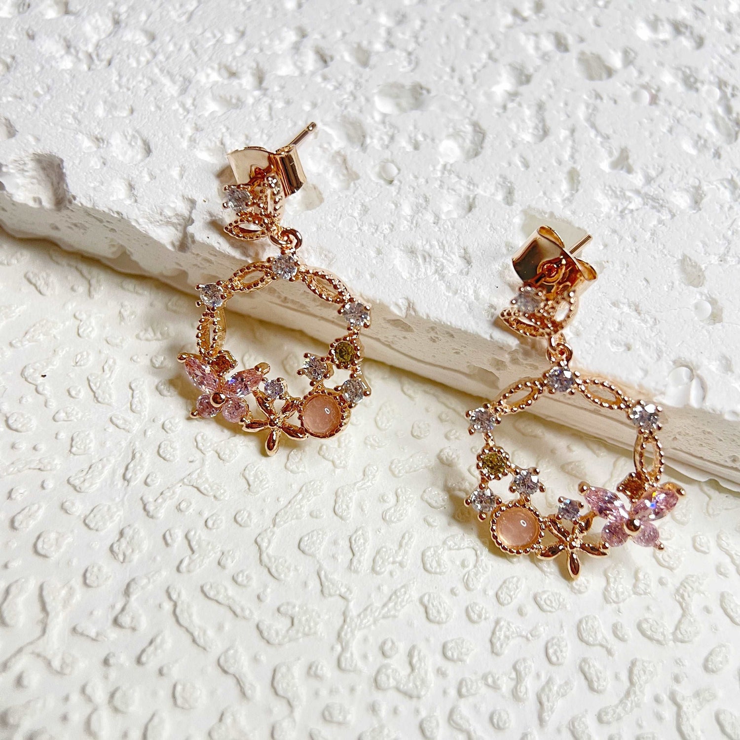 Pair of Rose Gold Drop earrings crafted with pink gemstone in butterfly design enriched by a flower wreath highlighted by Cubic Zirconia. Ideal  colorful Jewelry gift for her in different occasions - Sisilia Jewels